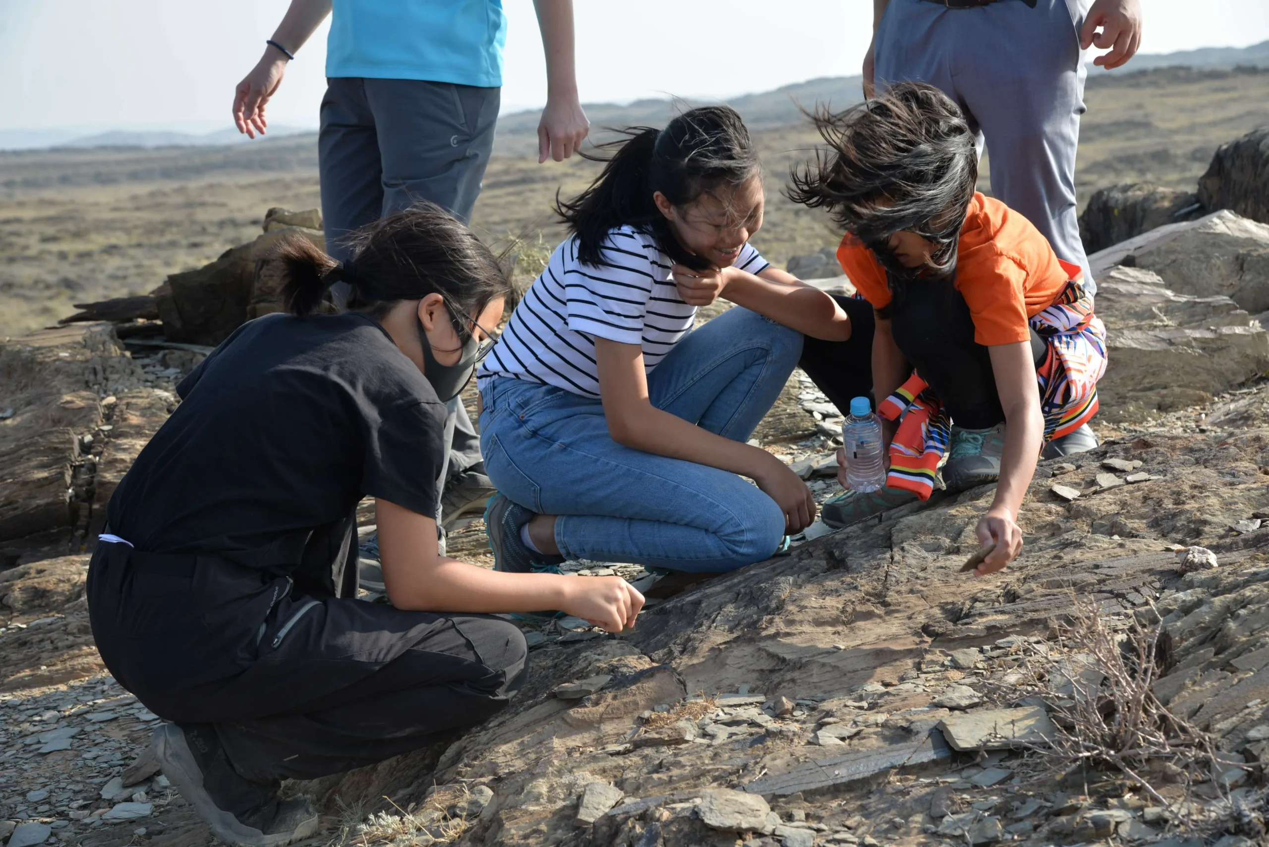 Kids checking petroglyphs