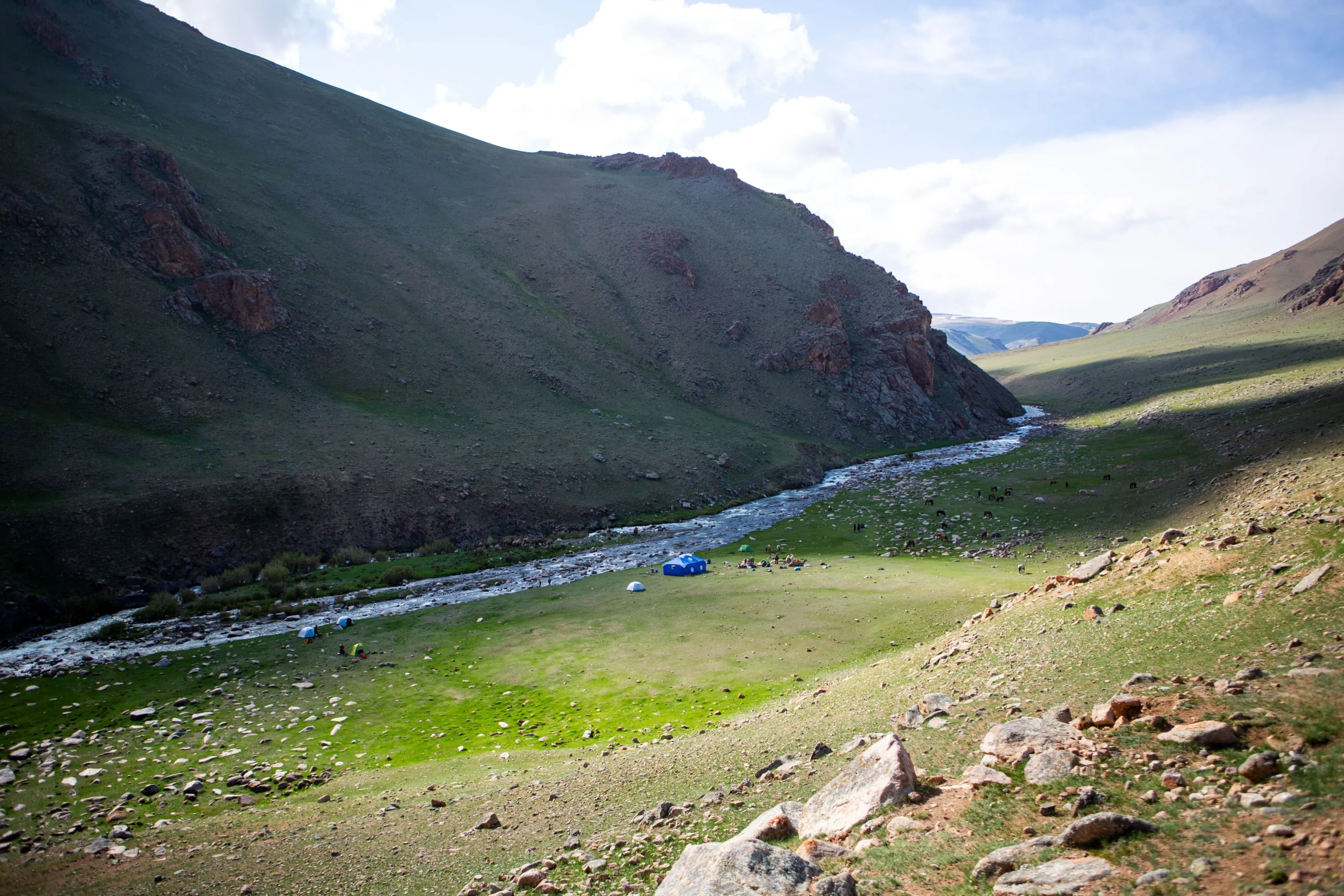 White water river and tents and horses